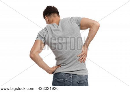 Millennial European Man Suffer From Muscle Pain, Pressing Hand To Back