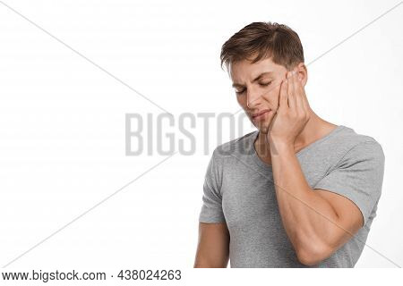 Unhappy Sad Attractive Millennial European Guy Suffering From Toothache, Feeling Unwell, Touching Ch