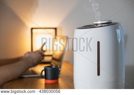 Close Up Of White Air Humidifier Spraying Steam. Humidification Of Dry Air. Selective Focus On Vapor