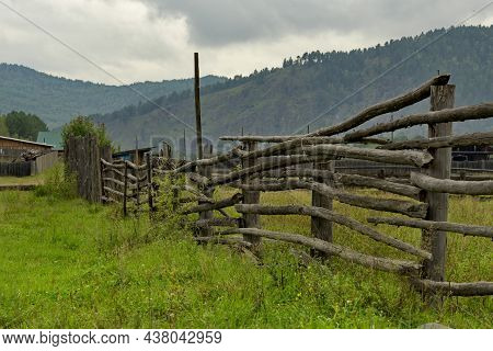 Russia. Transbaikalia, Chita Region. A Wooden Fence Made Of Boards And Poles, Which Enclose Pastures