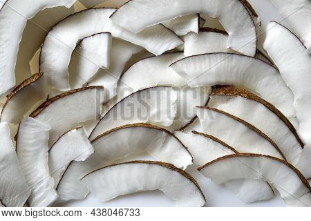 Slicing And Shavings Of Coconut On A White Plate