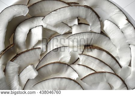 Slicing And Shavings Of Coconut On A White Plate