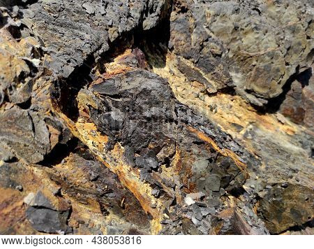 Geodesy. Stone Texture. The Rock Is Brown And Red. Mineral Background. Design From Natural Materials