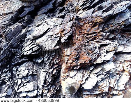 Geodesy. Stone Texture. The Rock Is Brown And Red. Mineral Background. Design From Natural Materials