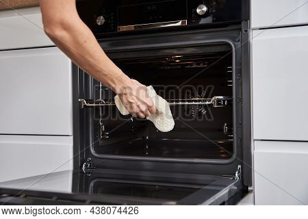 Woman Hand Open Electric Oven Door With Handle. Homemade Cooking. Kitchen Appliance