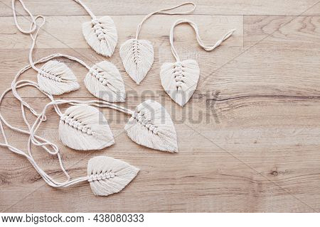 Macrame Leaves In Natural Color On The Wooden Background. Cotton Rope Decor Macrame To Make Your Hom