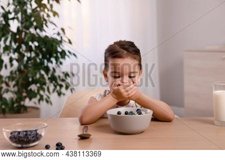 Cute Little Girl Covering Her Mouth And Refusing To Eat Breakfast At Home