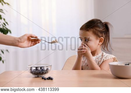 Cute Little Girl Covering Her Mouth And Refusing To Eat Breakfast At Home