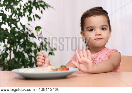 Cute Little Girl Refusing To Eat Her Breakfast At Home