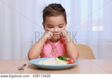 Cute Little Girl Refusing To Eat Her Breakfast At Home