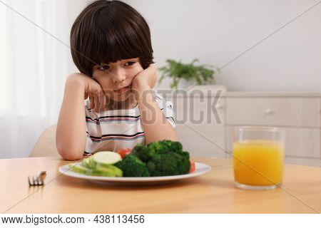 Cute Little Boy Refusing To Eat Vegetables At Home
