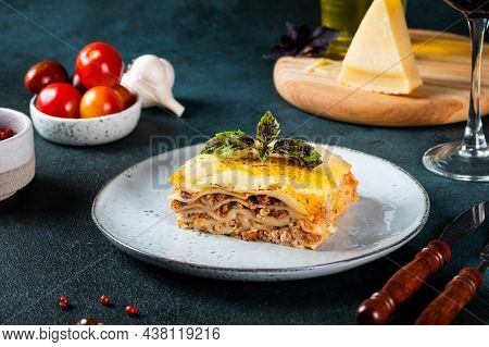 Piece Of Tasty Hot Lasagna On Dark Background. Traditional Italian Lasagna. Italian Food. Close Up L