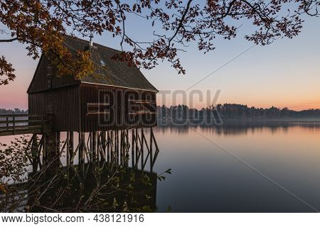 A Old Fisherman House With A Sunrise In The Background
