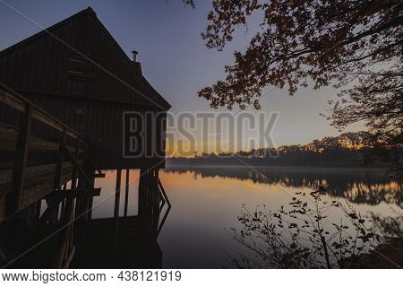 A Old Fisherman House With A Sunrise In The Background