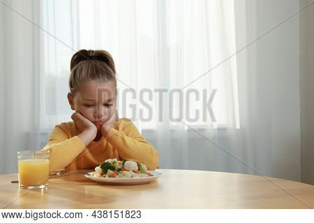 Cute Little Girl Refusing To Eat Vegetable Salad At Home, Space For Text
