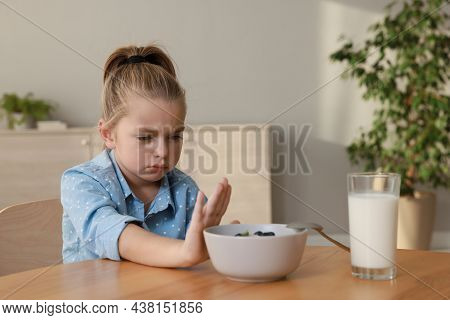 Cute Little Girl Refusing To Eat Her Breakfast At Home