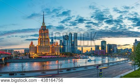 Illuminated Royal Hotel Radisson Near River At Evening In Moscow, Russia. Historic Name Is Hotel Ukr