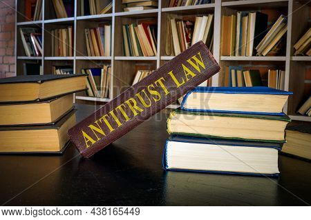 Pile Of Books And Antitrust Law Near The Shelf.