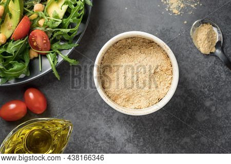 Nutritional Yeast Superfood In Ceramic Bowl. Plant-based Food Concept. Closeup