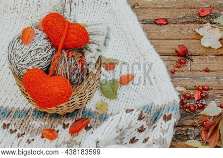 Autumn Knitting Of Warm Clothes. Woolen Balls Of Knitting Needles Knitted Hearts. Self-made Things W