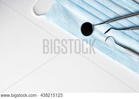 Dentist Tools And Medical Mask On White Background