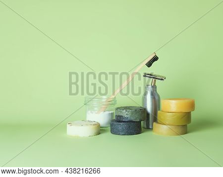 The Bamboo Toothbrush In The Glass With Toothpowder And The Steel Multiple-use Razor In The Bottle A