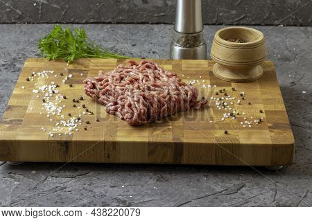 Ground Meat. Minced Meat With Ingredients For Cooking On A Black Background. Chopped Meat. View From