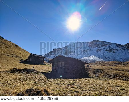 Farmhouse In The Mountains Above Monstein, Davos. Beautiful Autumn Landscape With Snowy Mountain Pea