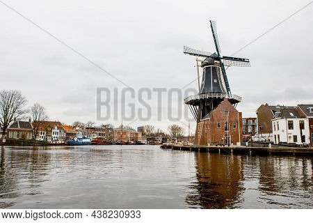 Cityscape Of Haarlem, The Netherlands. View Of Old Windmill And Typical Dutch Houses.