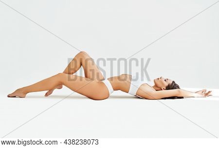 Sexy Sporty Woman In White Lingerie Posing Lying On Floor. Full Length Portrait