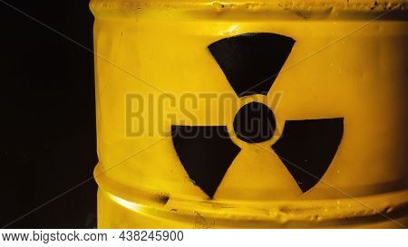 Yellow Metal Barrel With Radioactive Decay Symbol. Container With Nuclear Trefoil Warning Sign. Drum