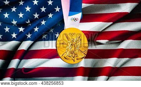 April 22, 2021 Beijing, China. Olympic Gold Medal Against The Background Of The Flag Of The United S