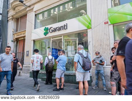 Beyoglu, Istanbul, Turkey - 08.03.2021: Turkish Garanti Bank Costumers Masks Standing Waiting In Lin