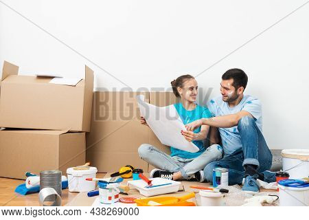Couple Discussing Home Redesign Ideas. Man And Woman Together Planning New Home Interior Design. Car
