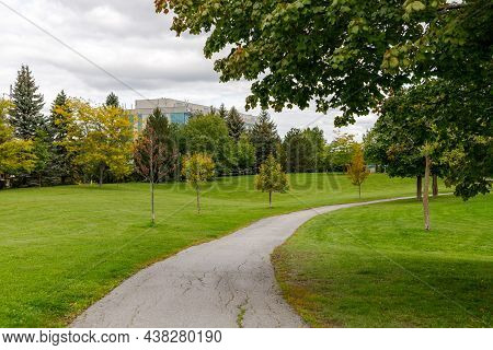 Centrepointe Public Park In Ottawa, Canada With Path, Green Grass And Trees In Early Autumn