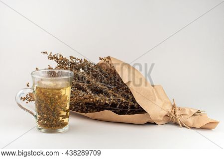 Herb Tea And Wormwood Twigs Wrapped In Brown Paper.
