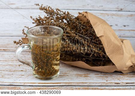 Herb Tea And Wormwood Twigs Wrapped In Brown Paper.