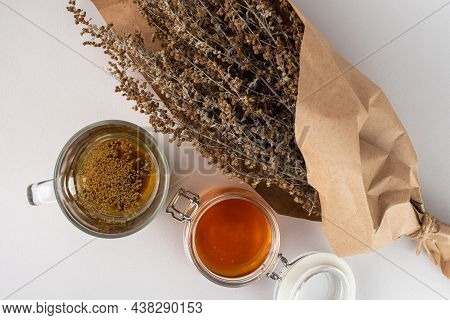 Herb Tea, Honey And Wormwood Twigs Wrapped In Brown Paper. Top View.