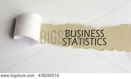 Business Statistics. Words. Text On Gray Paper On Torn Paper Background