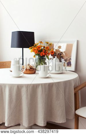 Round Table Serving For Morning Fresh Tea With A White Tablecloth And Flowers Bouquet. Set For Tea-t