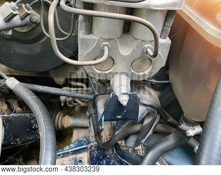 The Engine Compartment And Engine Of A Modern Car. In The Center Of The Frame Are Gears And Timing B