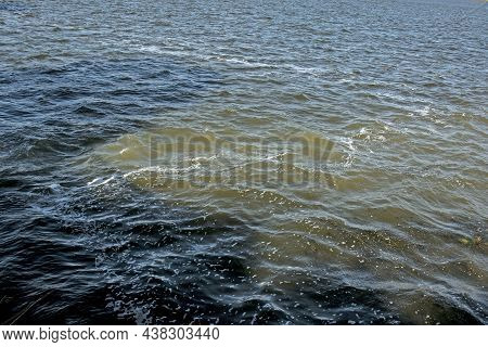 Dirty Orange Water From Sewage Pipeline Mixes With River Water.