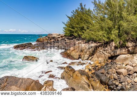 Cliff Rocks With Vegetation And Waves