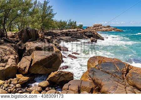 Cliff Rocks With Vegetation And Waves