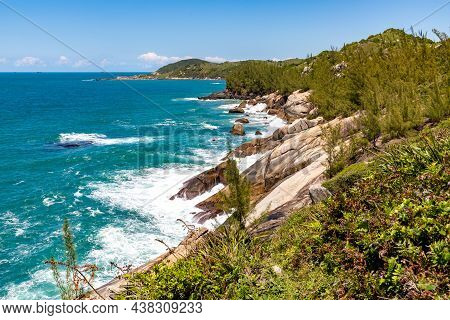 Cliff Rocks With Vegetation And Waves