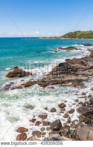 Beach View With Waves And Rocks
