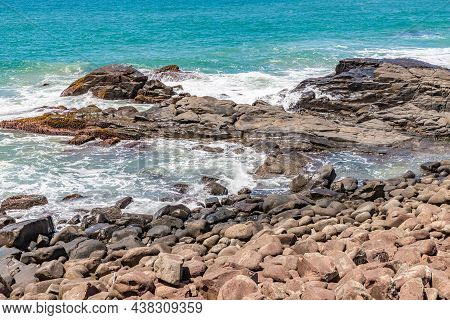 Beach View With Waves And Rocks