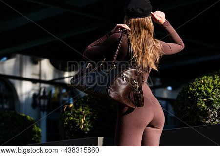 Fashionable Young Brunette Woman Wearing Solid Long Sleeve Bodycon One Piece Jumpsuits Posing With A
