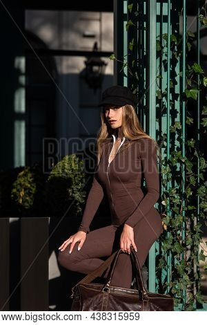 Fashionable Young Brunette Woman With Long Legs Wearing Solid Long Sleeve Bodycon One Piece Jumpsuit