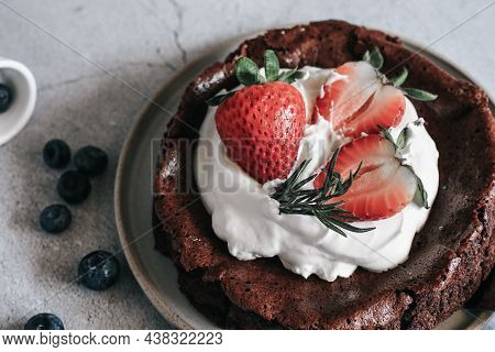 Flourless Chocolate Cake With Whipping Cream And Strawberry On Concrete Background. Homemade Cake Co